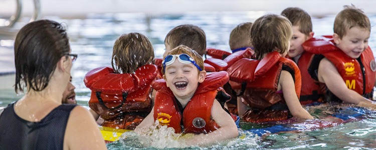 An image of children enjoying an aquatics class.